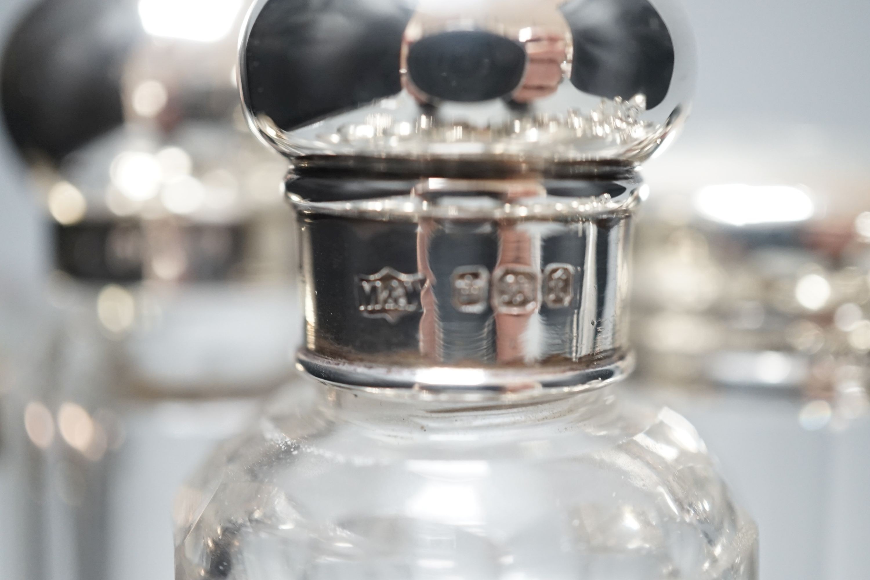 A collection of assorted mainly silver-capped scent bottles and toilet bottles.